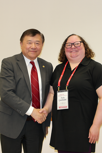 a man and woman smiling and shaking hands