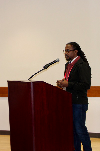man speaks at podium