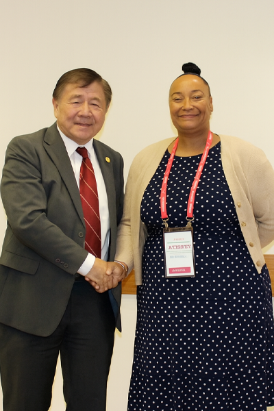 a man and woman smiling and shaking hands