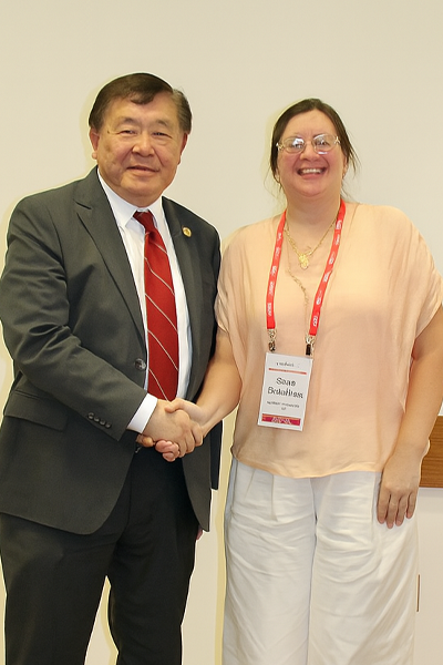 a man and woman smiling and shaking hands