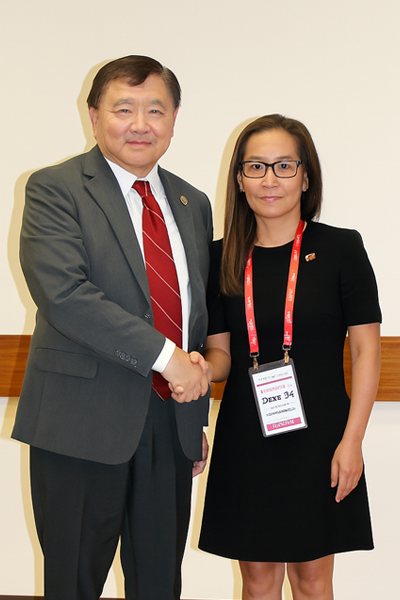a man and woman smiling and shaking hands