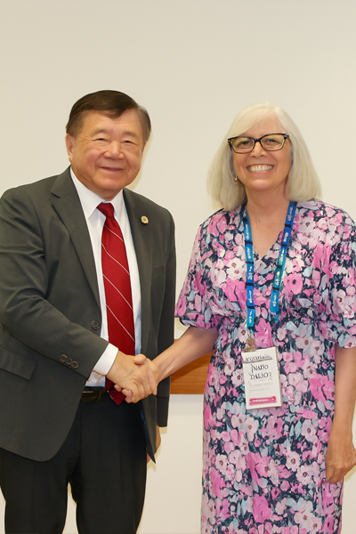 a man and woman smiling and shaking hands